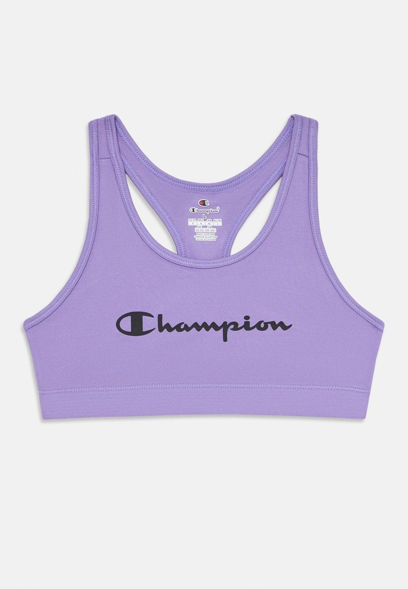Lavandas racerbaka sporta krūšturis ar melnu "Champion" logo centrā uz priekšpuses un redzamu izmēra etiķeti aizmugurē.