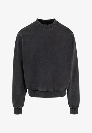 Black cropped sweatshirt with round neckline, ribbed cuffs, and hem. Made from soft fabric with a slightly faded appearance.