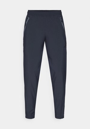 Pantalons de sport navy en tissu léger, dotés de deux poches zippées latérales, d'une taille élastique et de jambes fuselées pour un ajustement élégant.