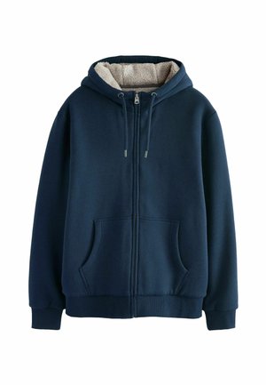 Mornarska zip majica s mekim bež flisom unutra, sa vezicama, dva prednja džepa, rebrastim manžetama i donjim rubom. Gladak spoljašnji tekstura.