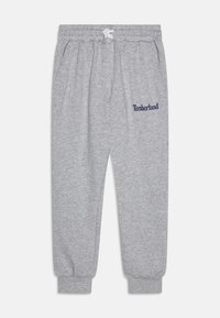 Šedé tepláky z bavlnenej zmesi, s elastickým pásom a šnúrkou, bočnými vreckami a logom "Timberland" v námorníckej modrej farbe.
