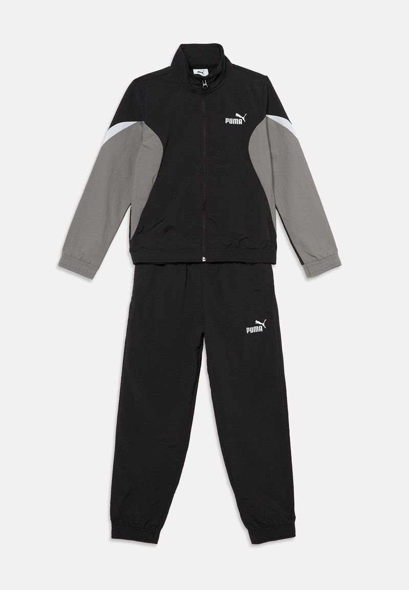 Survêtement Puma noir et gris avec veste zippée et poignets élastiques, présenté à plat sur fond blanc.