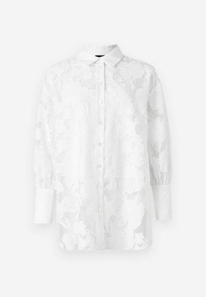 Biela košeľa s dlhým rukávom a kvetinovým čipkovým vzorom, s predným zapínaním na gombíky a manžetami. Priehľadná textúra s jemným povrchom.
