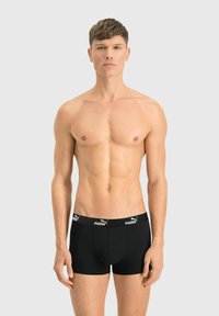 Black boxer briefs with a snug fit, made of soft fabric, featuring a contrasting logo waistband and a front pouch area.