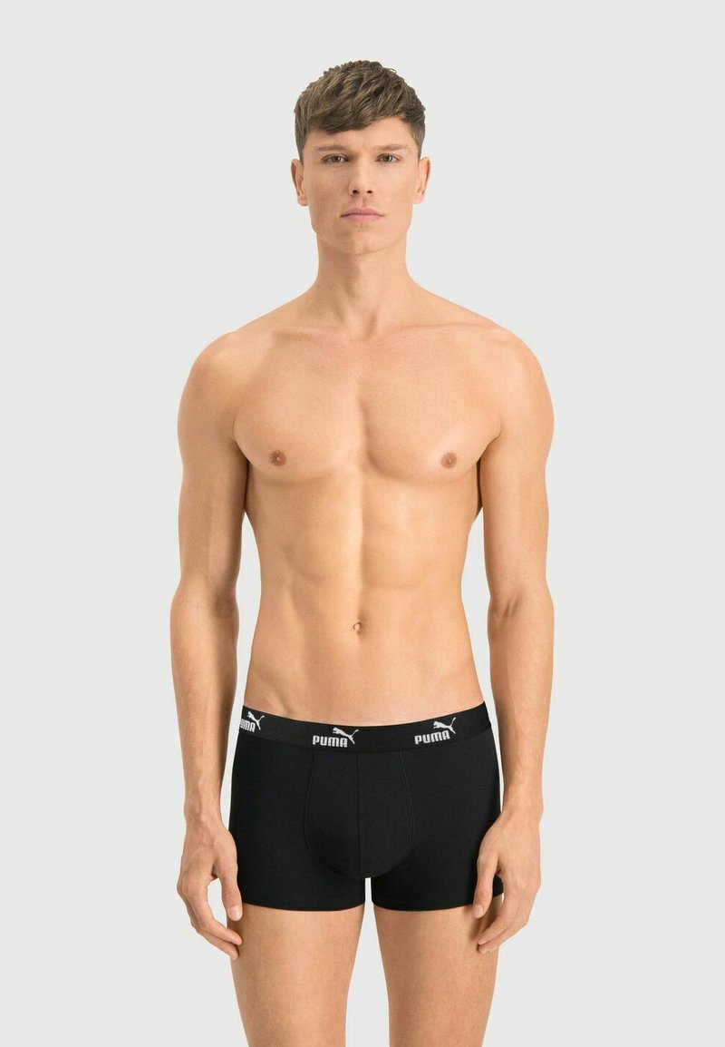 Black boxer briefs with a snug fit, made of soft fabric, featuring a contrasting logo waistband and a front pouch area.
