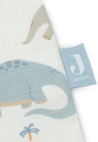 Tissu en coton avec des impressions de dinosaure en bleu clair et gris. Surface texturée avec un toucher doux. Comprend une étiquette bleue avec le logo "J".