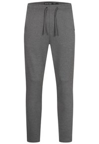 Gray sweatpants with a drawstring waistband, tapered leg design, soft texture, and a logo detail near the lower left leg.