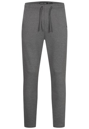 Szare spodnie dresowe z ściągaczem w pasie, zwężane nogawki, miękka struktura oraz detal z logo w dolnej części lewej nogawki.