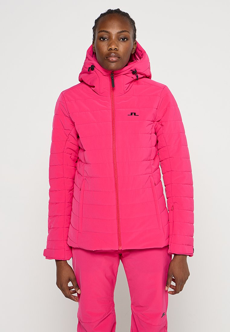 Gepolsterte rosa Jacke mit Reißverschluss auf der Vorderseite, hohem Kragen und verstellbarer Kapuze. Mit einem Logo auf der Brust und elastischen Bündchen.