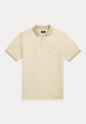 Beige polo skjorte med et teksturert mønster, to-knapp placket og en kontrasterende krage. Har en liten brodert logo på brystet.
