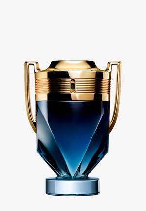Trophy-shaped perfume bottle with a blue faceted glass base and shiny gold handles and cap against a white background.