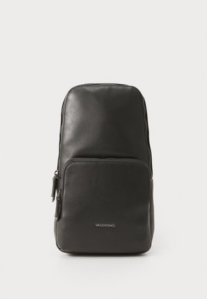 Black leather backpack with a smooth texture, featuring a zippered main compartment and a front pocket. Logo displayed on the front.