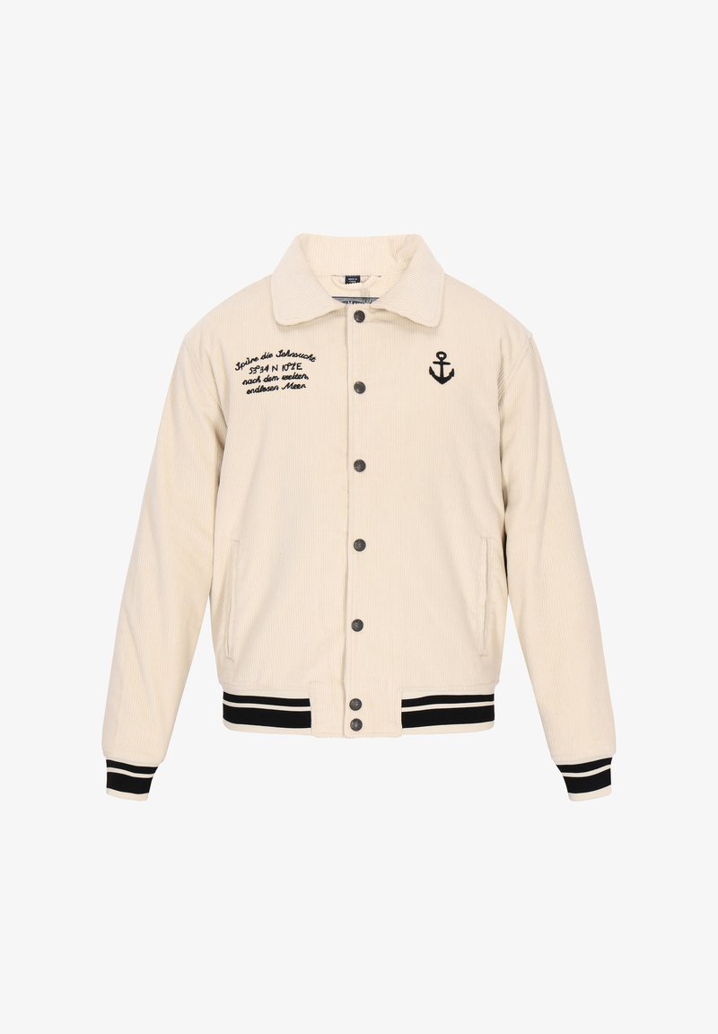 Beige corduroy jacket with black embroidery, button closure, side pockets, and contrasting black and white striped cuffs and hem.
