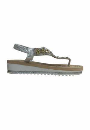 Silver wedge sandal with back strap and jeweled thong strap featuring green and blue stones, textured beige footbed, and ridged sole.