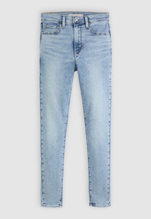 Világoskék farmer skinny nadrág magas derékkal, öt zsebbel és finom gyűrődés részletekkel. Simaság jellemzi, standard cipzárral és gombos zárással.