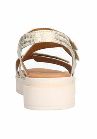 Metallic gold open-toe sandals with a crocodile texture, featuring cross straps and a thick white platform sole.