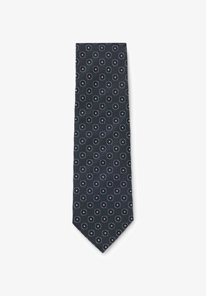 Cravate bleu marine avec un motif répétitif de petits dessins circulaires blancs uniformément espacés sur le tissu.