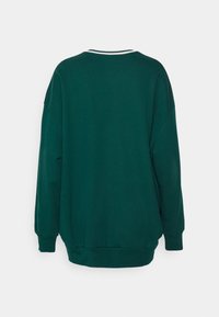 Felpa verde dalla vestibilità rilassata, con collo tondo, maniche lunghe e dettagli a costine su collo e polsini. Texture liscia.