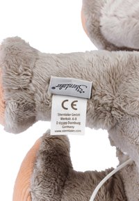 Plush gray toy with soft fur and a smooth texture, featuring a light orange accent, CE label, and brand tag on the underside.