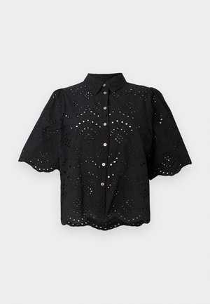 Black short-sleeve shirt featuring eyelet embroidery, scalloped hem, and button closure. Lightweight fabric with floral cut-out patterns.