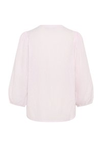 Blouse rose clair en tissu texturé à pois, col rond et manches bouffantes. Design arrière sans couture.