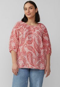 Bloemrijke blouse in tinten van roze en wit. Opgeblazen mouwen en een geraffineerde halslijn. Lichtgewicht stof met een gestructureerde afwerking.