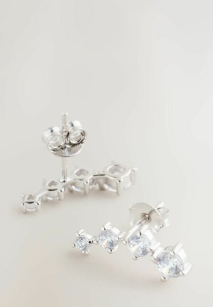 Silver stud earrings with three clear gemstone accents, featuring a linear design and smooth texture, set in a minimalist style.