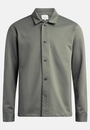 Green button-up shirt made of smooth fabric, featuring a collar, front button closure with dark buttons, and long sleeves.