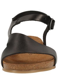 Sandal in pelle nera con soletta in sughero, cinturino regolabile alla caviglia e design con punta aperta. Texture liscia con contrasto tra i materiali.