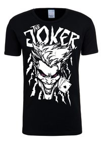 Black t-shirt featuring a large white graphic of a Joker face with pink eyes and playing cards, made from cotton with a crew neck design.