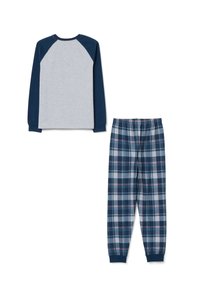 Grijze lange mouwen top met marineblauwe raglanmouwen, gecombineerd met marineblauwe en grijze geruite broeken met elastische tailleband en taps toelopende pijpen.