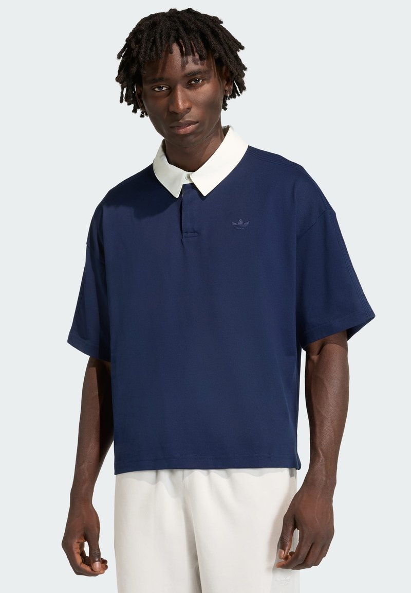 Navy blue short-sleeved polo shirt with a white collar, textured fabric, and a subtle logo on the left side. Loose fit design.