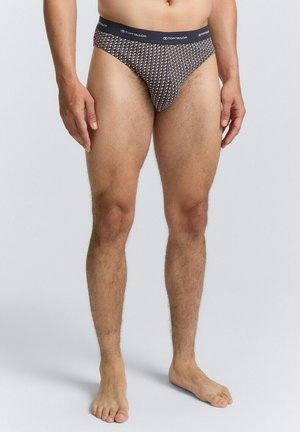 Herenboxershort, gemaakt van zachte stof, met een marineblauwe basis en een geometrisch patroon in wit en lichte kleuren, en een effen donkere tailleband.