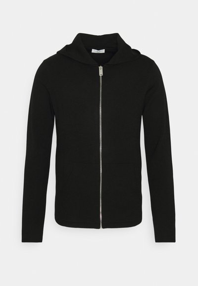 Haut à capuche zippé noir en tissu doux, doté d'une capuche, de manches longues et de poches avant. Design simple et minimaliste.