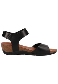 Černá kožená sanda s korkovým klínem, nastavitelným páskem kolem kotníku, otevřenou špičkou a hladkým povrchem v minimalistickém stylu.