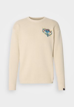 Beige sweater with ribbed cuffs, round neckline, and textured fabric. Features colorful embroidered design on the chest with abstract elements.