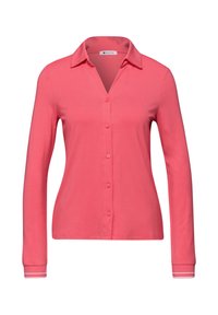 Chemise corail à manches longues avec col, boutonnière sur le devant et accents à rayures contrastantes aux poignets. Tissu lisse et extensible.