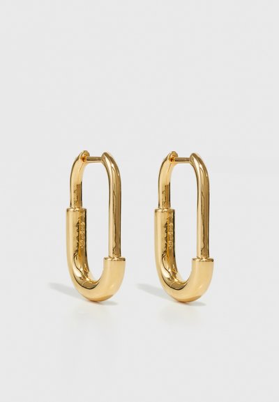 Gold metal hoop earrings with an elongated oval shape, featuring a smooth, polished surface and a small hinge for attachment.