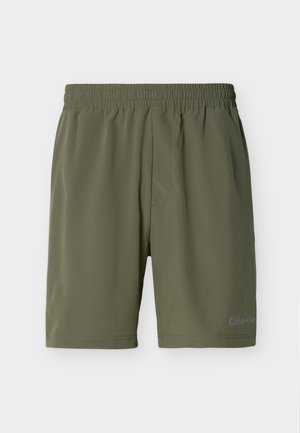 Pánské šortky olivově zelené barvy s elastickým pasem a nenápadným logem Calvin Klein na spodní části levé nohy, jednobarevné provedení.