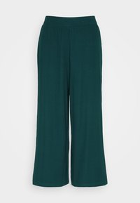 Pantalon large vert foncé avec taille élastique et texture à côtes verticales discrètes, présenté sur fond blanc.