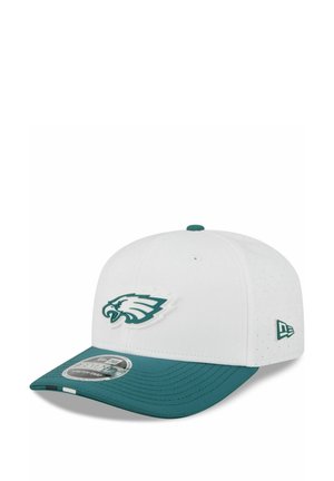 White and green baseball cap with Philadelphia Eagles logo on front and New Era logo on side.