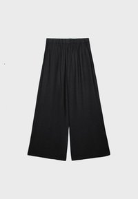 Pantalon ample noir à taille élastique, en tissu léger, présenté à plat sur un fond clair uni.