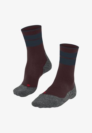 Chaussettes marron et grises avec un haut côtelé, présentant des rayures bleues et une zone de pied renforcée. Fabriquées à partir d'un mélange de matériaux confortables.