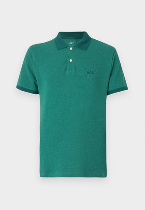 Vihreä polo-paita, joka on valmistettu teksturoidusta materiaalista. Paita on napillinen kaulus, lyhyet hihat ja siinä on pieni logo rinnassa.