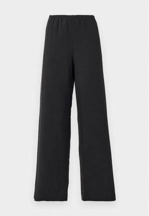 Schwarze, weit geschnittene Hosen aus weichem Stoff, mit einem elastischen Bund und einer glatten, matten Textur ohne Muster oder Akzente.