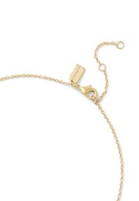 Gold chain bracelet featuring a lobster clasp, adjustable length, and a rectangular tag with embossed logo detail. Smooth texture.