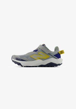 Gray athletic shoe with a breathable mesh upper, yellow accents, and a secure strap. Features a thick white midsole and textured rubber outsole.