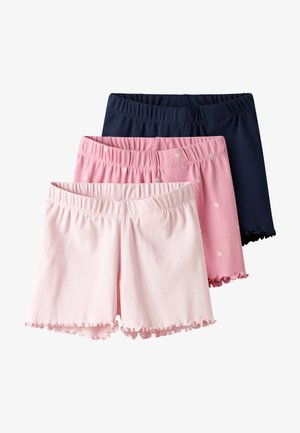 Three pairs of girls' elastic waist shorts in navy blue, pink with white hearts, and light pink with ruffled hems.