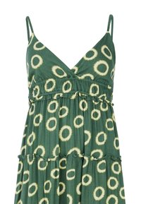 Robe verte sans manches avec fines bretelles, col en V, taille froncée et motifs circulaires jaunes sur tout le tissu.