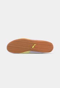 Shoe sole features a textured rubber surface in orange with yellow, lime green, and gray accents. Includes logo detail and a herringbone pattern.